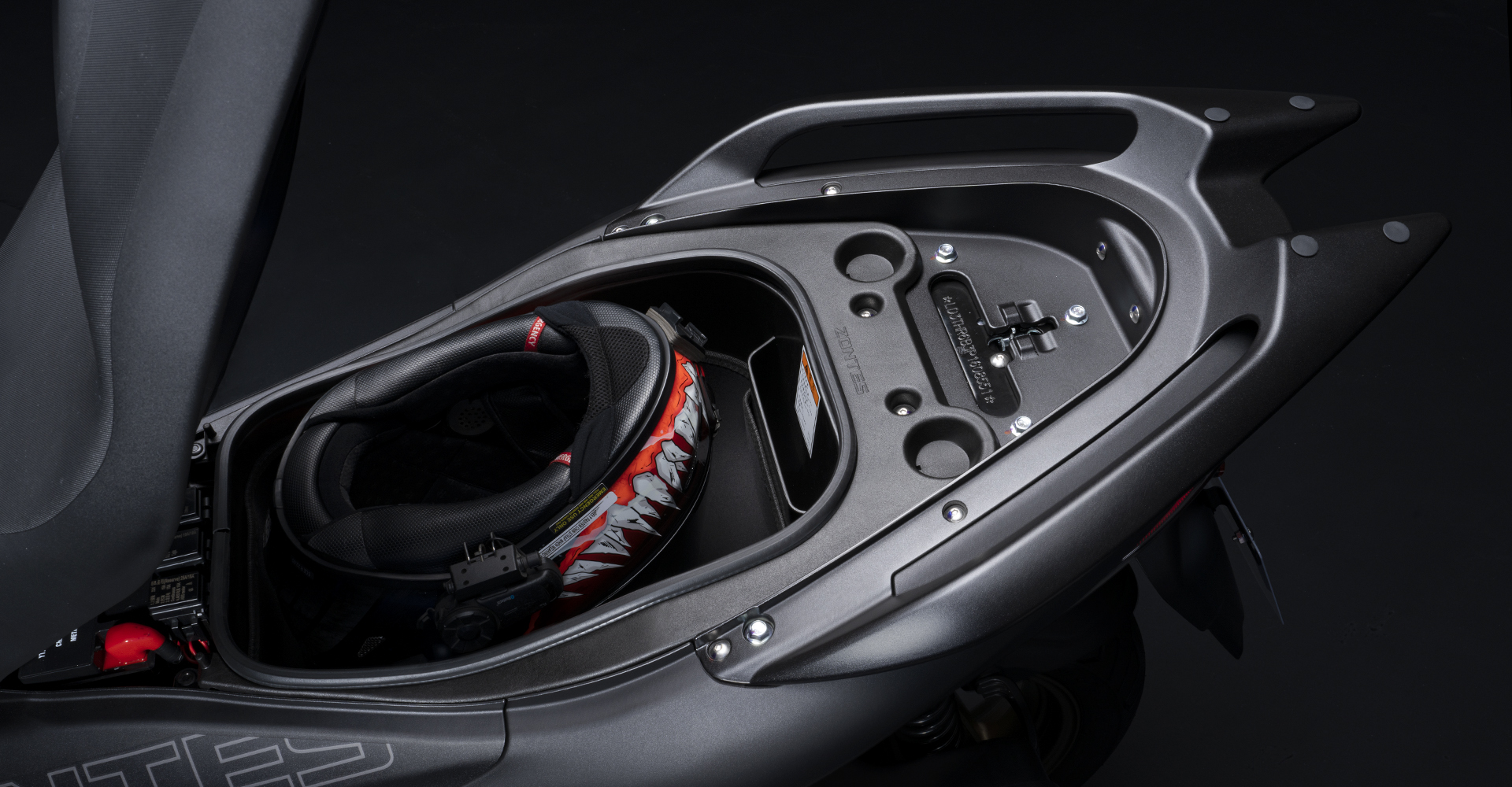16 Rear storage box able to accommodate the full face helmet